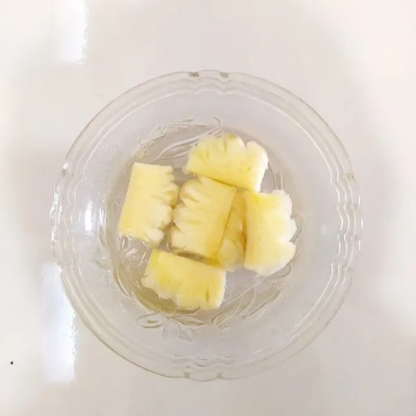 Potong-potong nanas lalu cuci bersih dan rendam dengan air garam selama 15 menit lalu bilas hingga bersih.