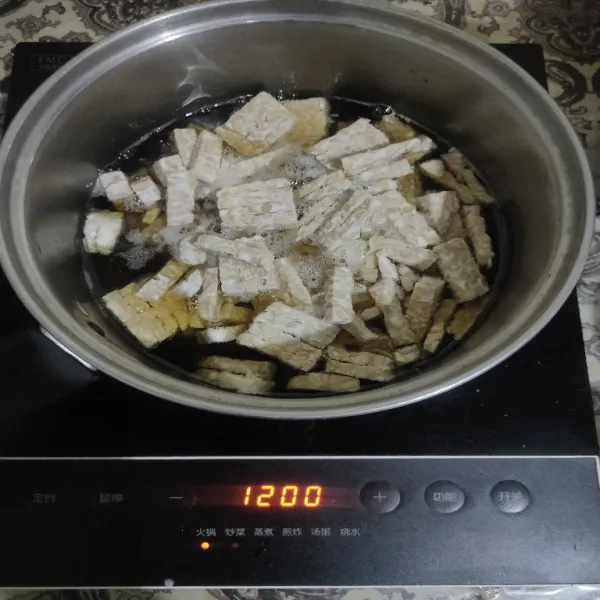 Kemudian panaskan minyak, goreng tempe hingga matang, angkat lalu tiriskan.