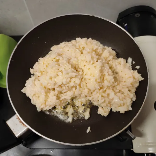 Lelehkan 1/2 sdm margarin, masukan nasi beri 1/2 sdm kaldu jamur, masak hingga masak merata supaya tidak berbau telur mentah.