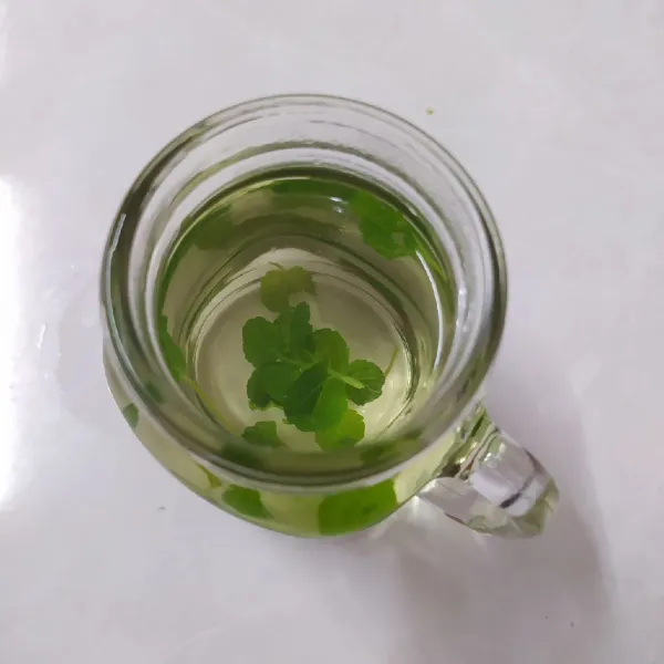 Ambil gelas saji, tuang air rebusan daun mint secukupnya. (Boleh disaring tanpa daun).