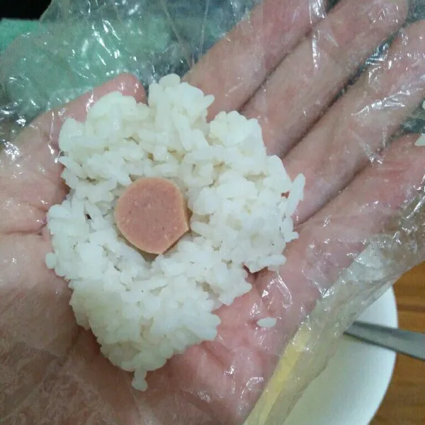 Ambil secukupnya nasi, letakan sosis lalu bulatkan.