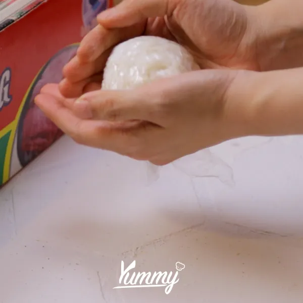 Bentuk nasi berbentuk bundar menggunakan plastik dengan cara dikepal.