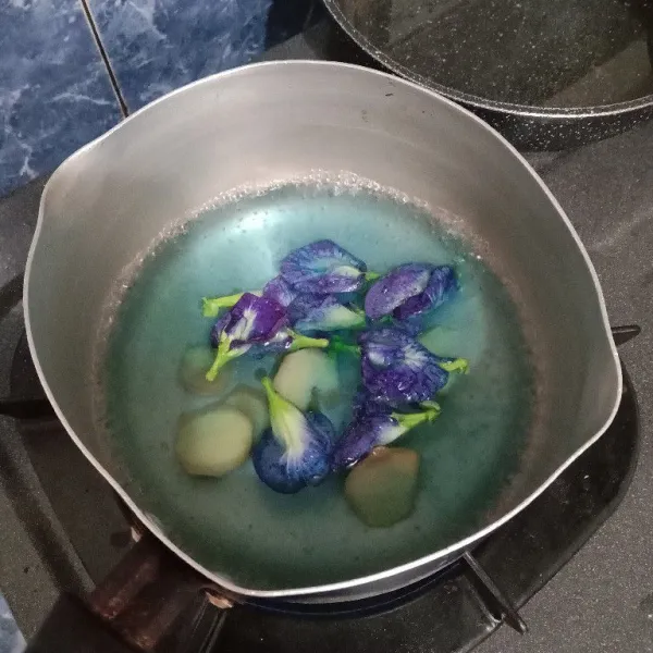 Didihkan air 250 ml lalu masukkan jahe dan bunga telang. Masak sampai air berubah menjadi biru. Matikan kompor