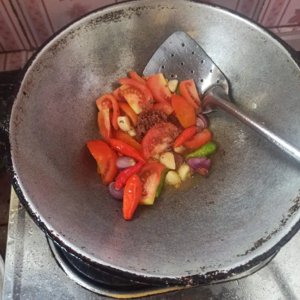 Goreng bawang merah, bawang putih, tomat dan cabai rawit sampai layu. Setelah bahan sambal setengah matang masukkan terasi goreng hingga matang.