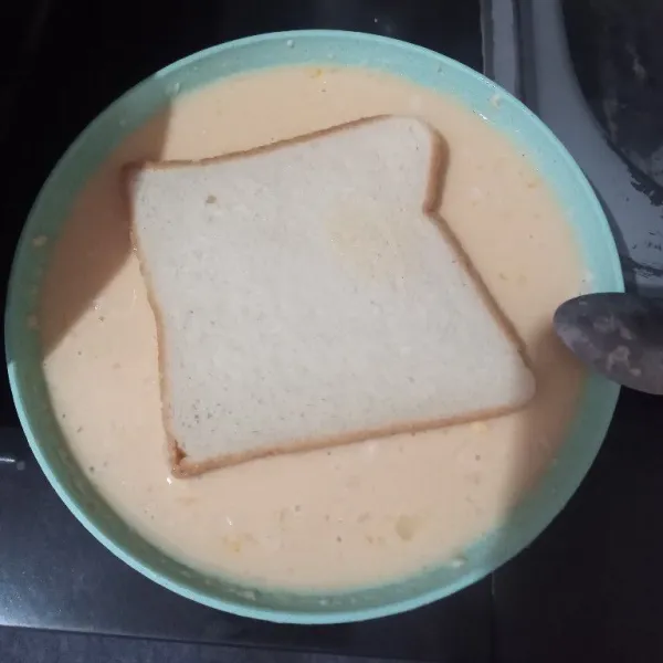 Masukkan roti tawar, bolak balik hingga roti terbalut adonan