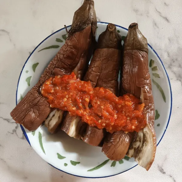 Kemudian penyet terong dengan ulekan. Lalu tambahkan sambal diatasnya. Dan siap disajikan.