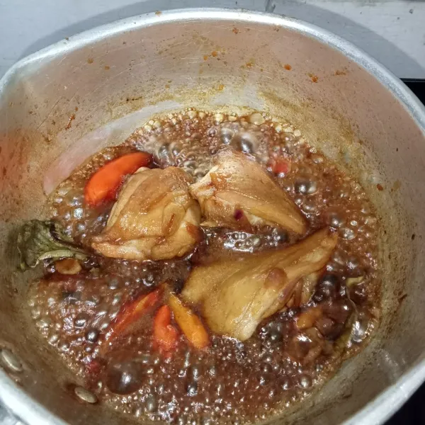 Tuang air dan aduk rata. Tunggu sampai air sedikit berkurang, lalu masukkan tomat dan cabai rawit.