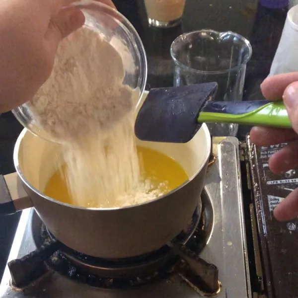Masukkan air, mentega, dan tepung kedalam panci, lalu aduk hingga tidak ada yang menggumpal, setelah itu pindahkan ke wadah lalu tunggu hingga tidak panas.