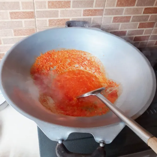 Haluskan bawang putih, tomat dan cabai. Tumis bumbu hingga harum.
