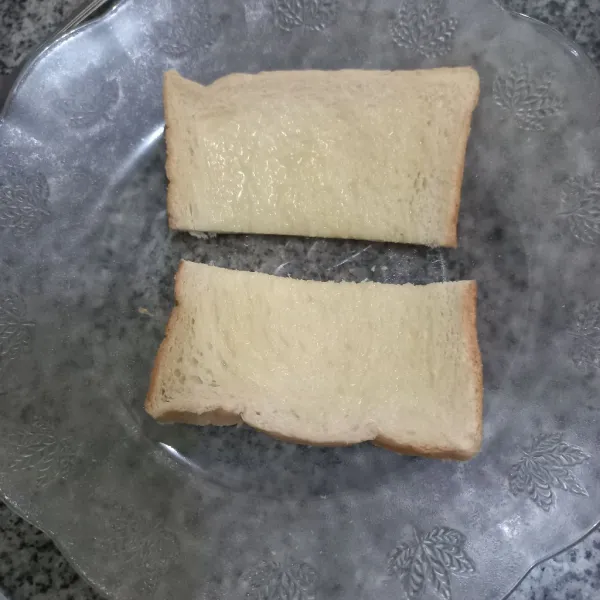 Potong roti menjadi 2 bagian.