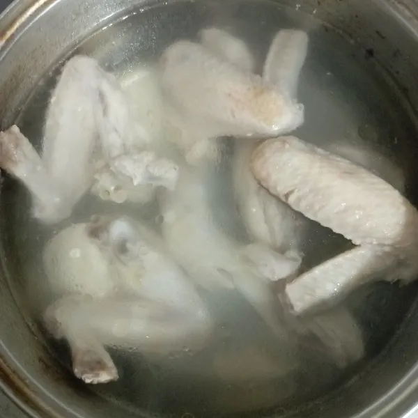 Rebus ayam yang sudah dibersihkan sampai mendidih lalu angkat dan buang air rebusan, kemudian rebus kembali ayam dengan air bersih.