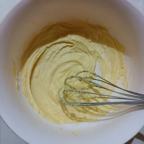 Tuang gula halus dan mentega di dalam wadah. Aduk dengan menggunakan whisk sampai creamy.