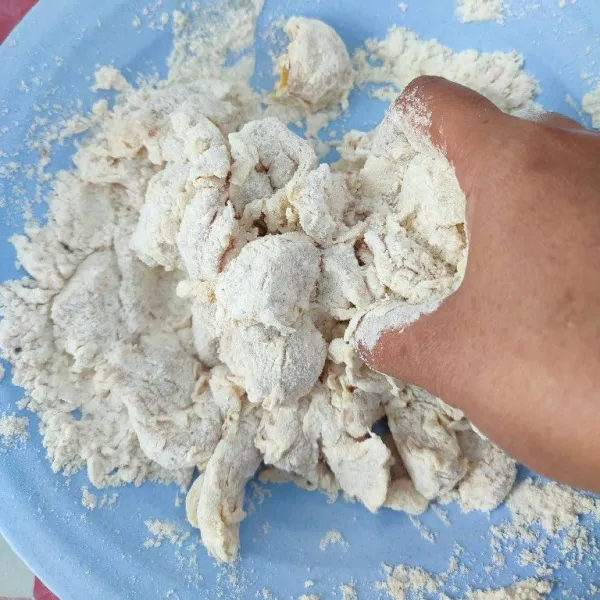 Masukkan kembali ke dalam adonan tepung kering sambil diremas pelan-pelan. Aduk dengan tepung sampai masing-masing daging ayam terpisah.