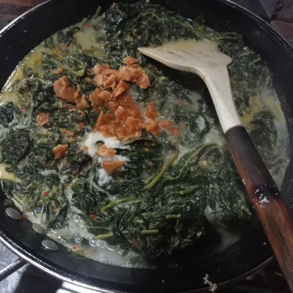 Tuang santan, masukan juga garam, gula merah dan kaldu bubuk, aduk rata masak sampai mendidih dan tanak, cek rasa.