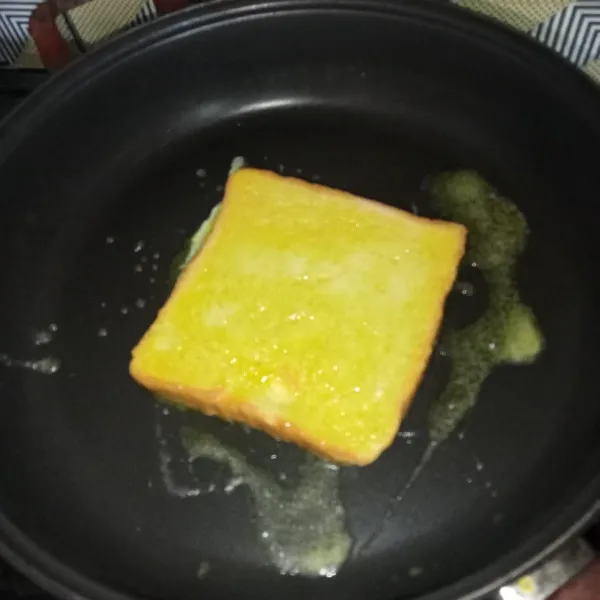 Panaskan margarin dan letakkan roti, gunakan api kecil saja.