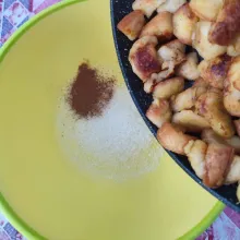 Siapkan wadah kedap udara, tambahkan kayu manis bubuk dan gula. Masukkan roti pisang panggang ke dalamnya. Kocok hingga tercampur rata.