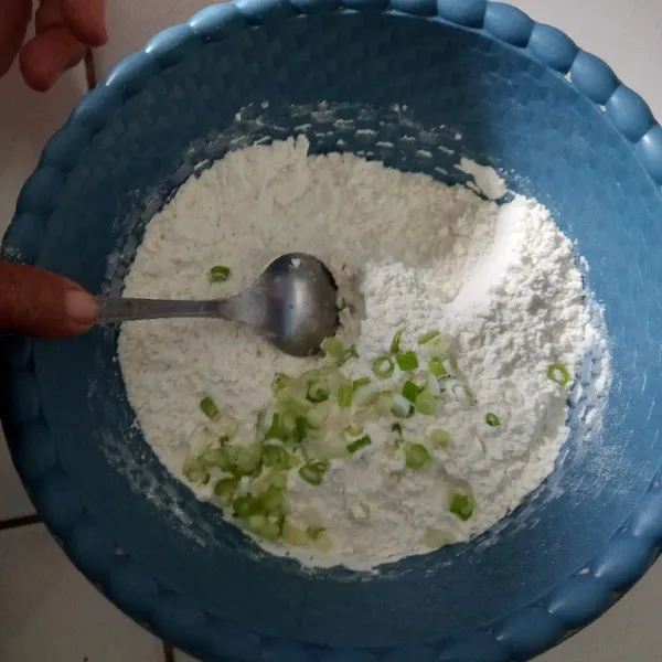Dalam wadah masukkan tepung terigu, irisan daun bawang, garam, penyedap.