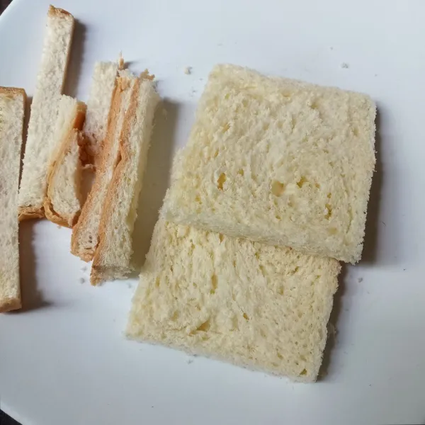 Potong pinggiran roti, lalu gilas roti sampai pipih.