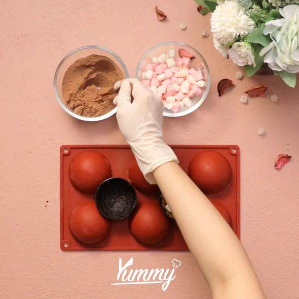 Beri isian minuman bubuk coklat dan marshmallow ke dalam coklat. Tutup dan ratakan pinggirnya dengan bantuan jari.