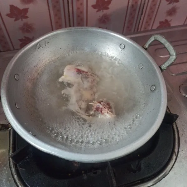 Rebus tulang ayam dan sejumput garam hingga mendidih, sisihkan terlebih dahulu.
