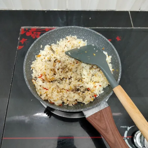 Masak sambil terus diaduk hingga nasi agak mengering, lalu angkat.