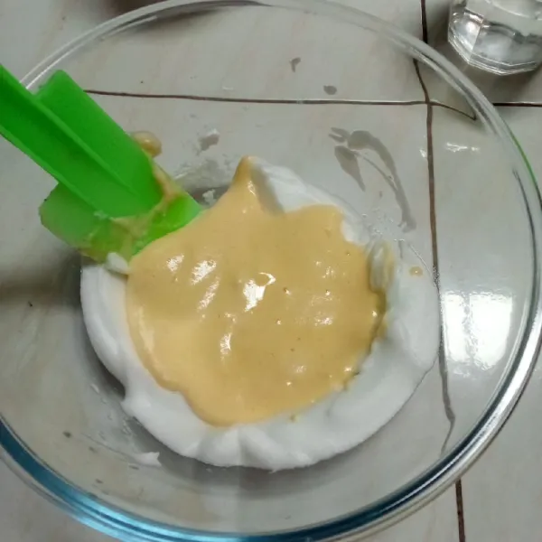 Masukkan hasil campuran ke sisa kocokkan putih telur lalu aduk rata.