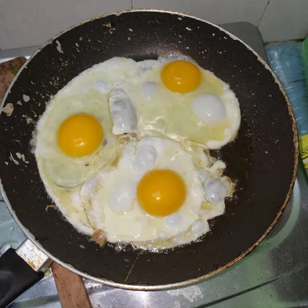 Ceplok telur hingga matang kedua sisinya, angkat dan sisihkan.