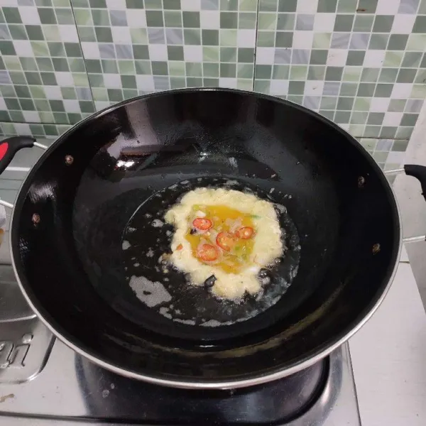 Panaskan minyak goreng agak sedikit banyak, kemudian masukkan 1 sendok sayur adonan telur.