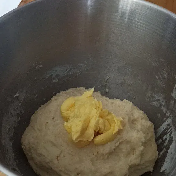 Setelah 30 menit, tambahkan mentega dan garam, uleni selama 7 menit atau hingga adonan tercampur rata dan menyatu. Diamkan selama 1 jam.