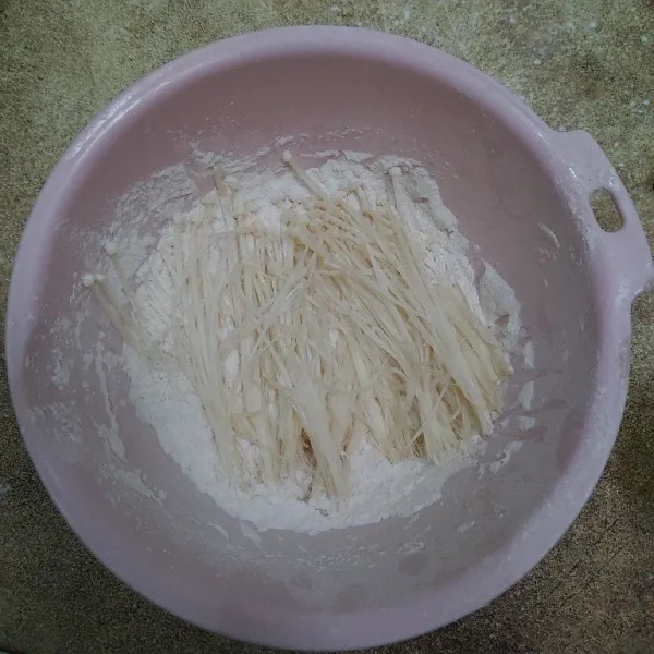 Masukan jamur enoki ke dalam campuran tepung.