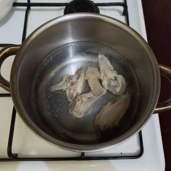 Didihkan air, masukkan potongan sayap ayam rebus.