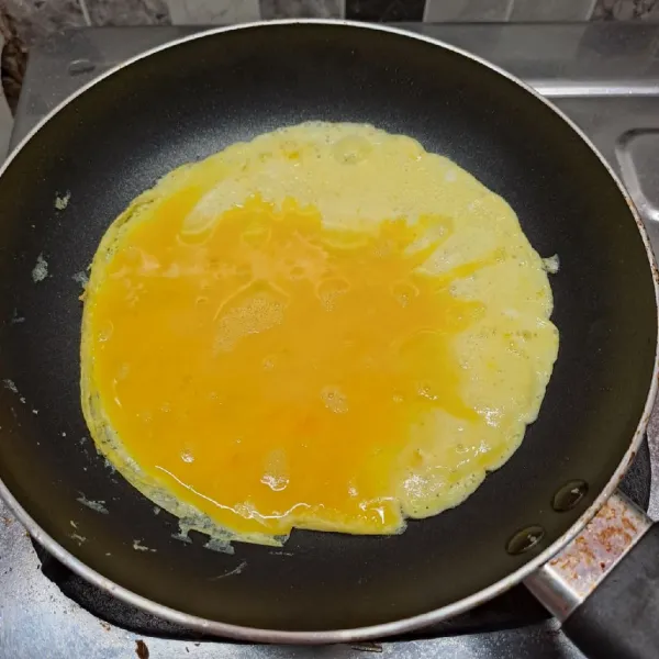 Panaskan teflon dengan sedikit minyak goreng. Tuang adonan telur, ratakan. Masak ½ matang.