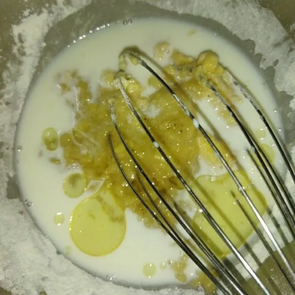 Tambahkan tepung terigu, garam, vanili bubuk dan baking powder, aduk rata, lalu masukkan pisang, susu cair dan minyak goreng.