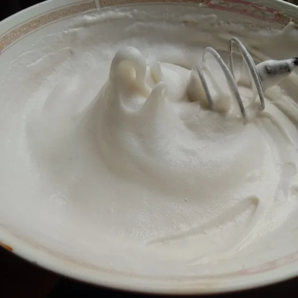 Kocok putih telur dan gula pasir sampai pucat dan mengembang, lalu masukkan tepung terigu. Kocok lagi sampai soft peak. Masukkan ke dalam piping bag.