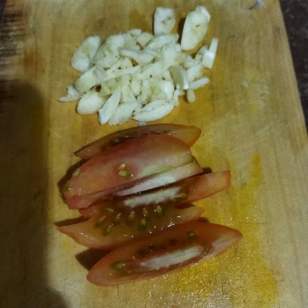 Lalu iris bawang putih dan tomat.