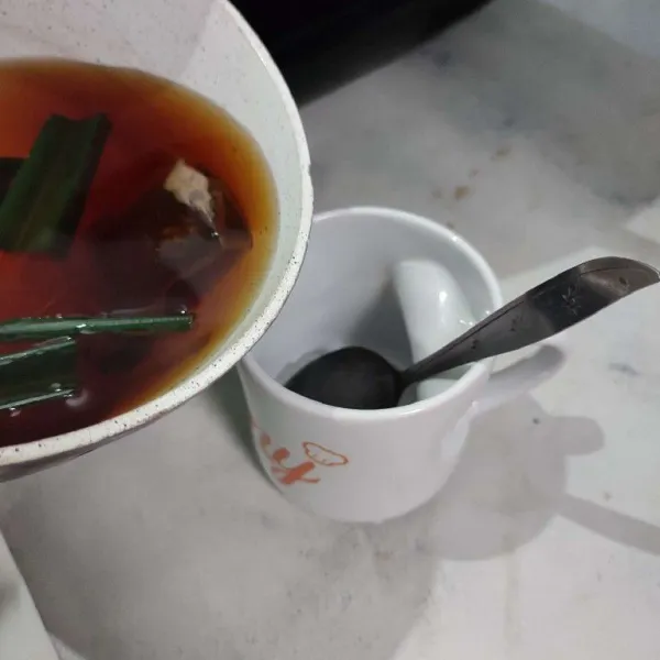 Tuang air rebusan teh ke dalam gelas.