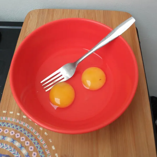 Masukkan telur ke dalam mangkuk, lalu kocok lepas.