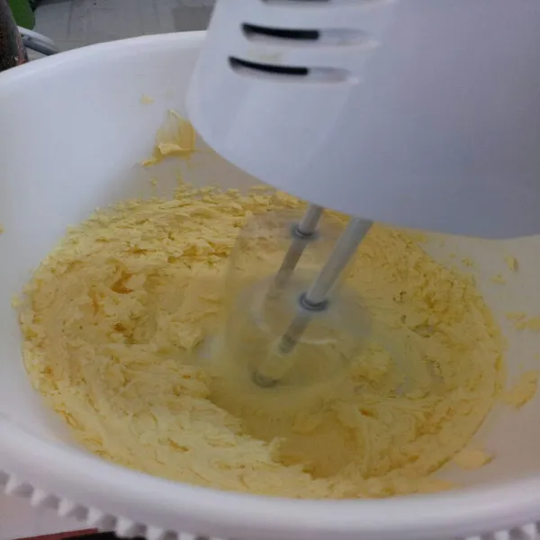 Masukan mentega, gula dan vanilli kedalam wadah lalu mixer dengan kecepatan sedang hingga kental putih berjejak.