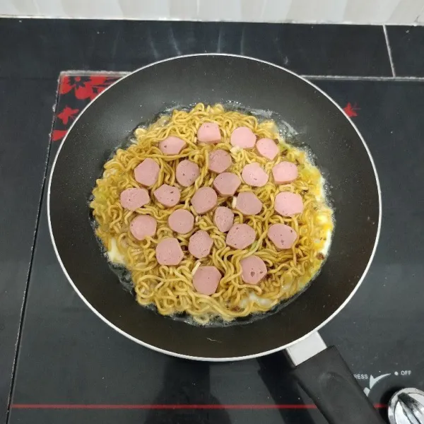 Setelah itu tata potongan sosis di atasnya. Masak hingga bagian bawah matang.