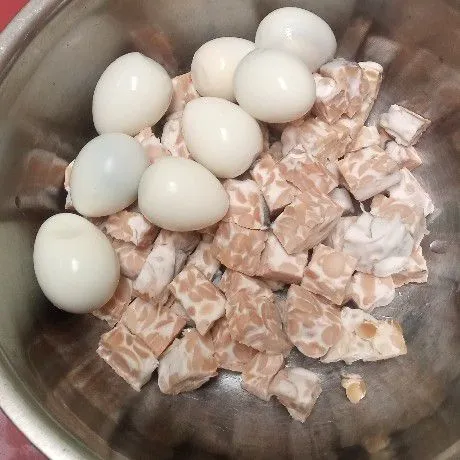 Rebus terlebih dahulu telur puyuh, kemudian kupas. Untuk tempe, dipotong kotak-kotak kecil.