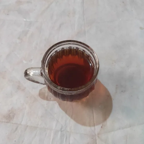 Tuang teh dalam gelas saji.