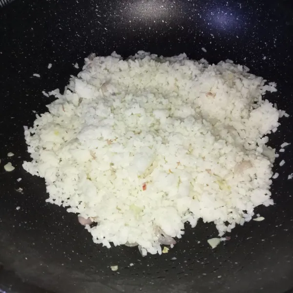 Masukkan nasi dan aduk-aduk sampai tercampur rata.