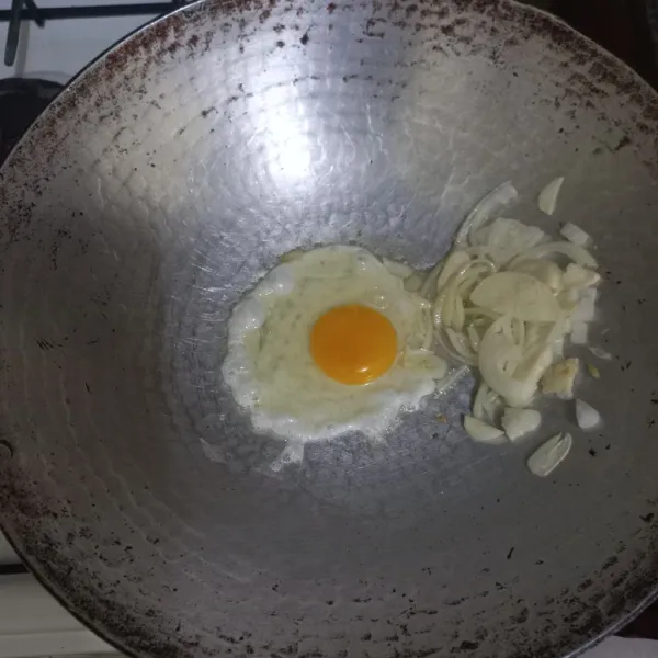 Tumis irisan bawang putih dan bawang bombay hingga harum, sisihkan di pinggir wajan. Masukkan telur ayam beri sedikit garam kemudian orak-arik.