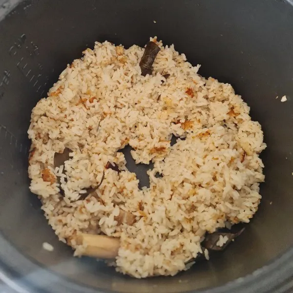 Masak nasi dengab rice cooker, lalu segera aduk nasi saat sudah matang. Agar tidak gosong pada bagian bawah.