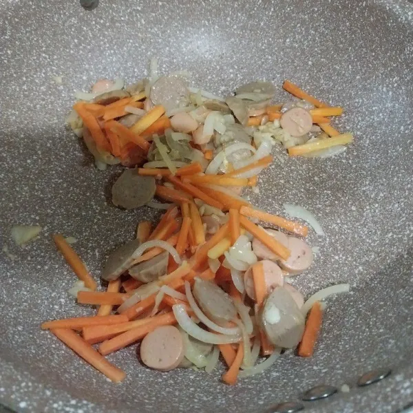 Tumis bawang putih dan bawang bombay sampai harum bersama minyak wijen. Masukkan sosis, bakso, dan wortel. Aduk dan masak sampai setengah matang.