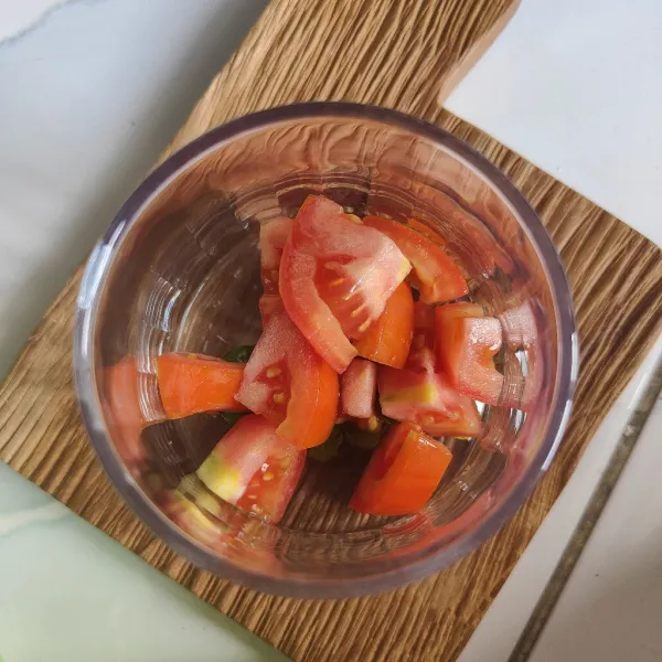 Masukkan tomat yang sudah dipotong-potong ke dalam gelas