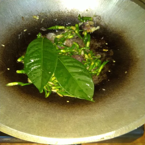 Masukkan irisan cabe keriting hijau, daun salam dan lengkuas. Aduk rata dan masak sampai cabe cukup layu.
