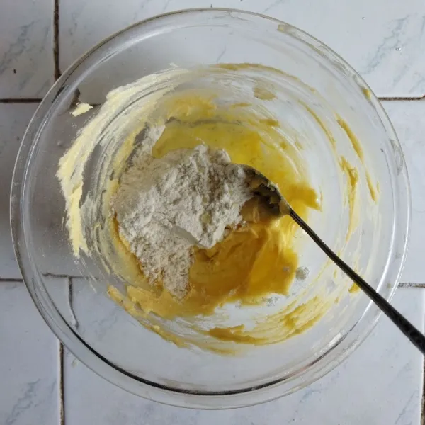 Tambahkan tepung terigu dan garam ke dalam adonan secara perlahan hingga habis lalu aduk perlahan.