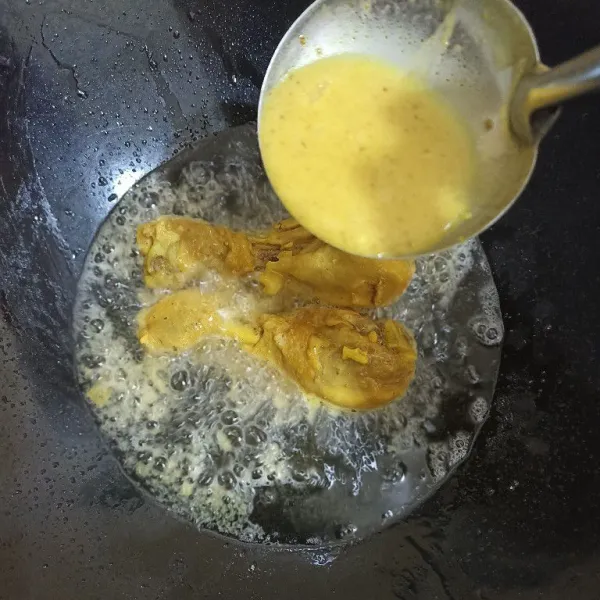 Panaskan minyak, goreng ayam sambil tuang sedikit air rebusan ayamnya di atas ayam yang masih digoreng. Goreng sampai kuning keemasan. Angkat dan tiriskan.