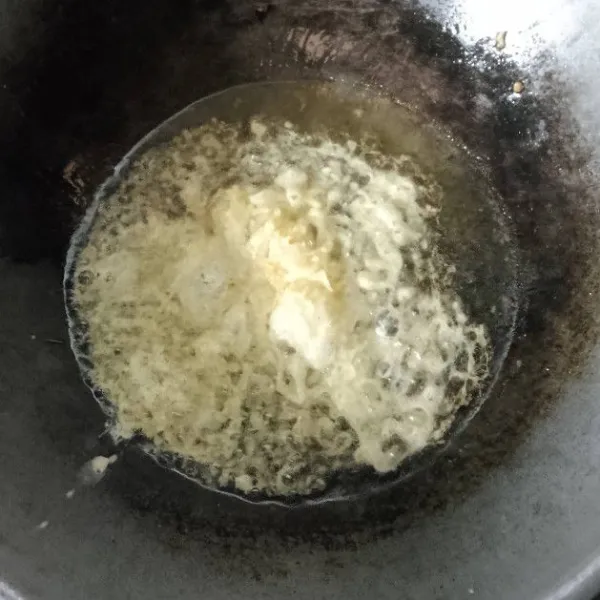 Tuangkan telur ke dalam minyak dari jarak sekitar 20 cm ke minyak.